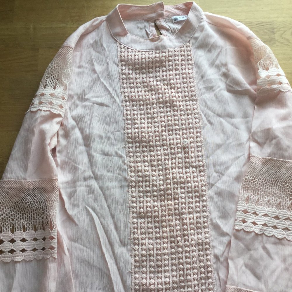 Aqe fashion light pink with crochet inserts in the sleeves and sown the front.
